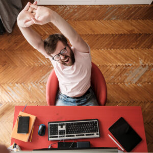 man stretching at desk - healthy habits: move more, sit less